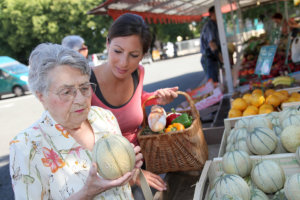 caregiver assisting senior woman in buying foods