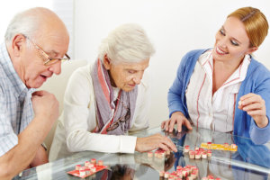 Caregiver assisting seniors in their activity
